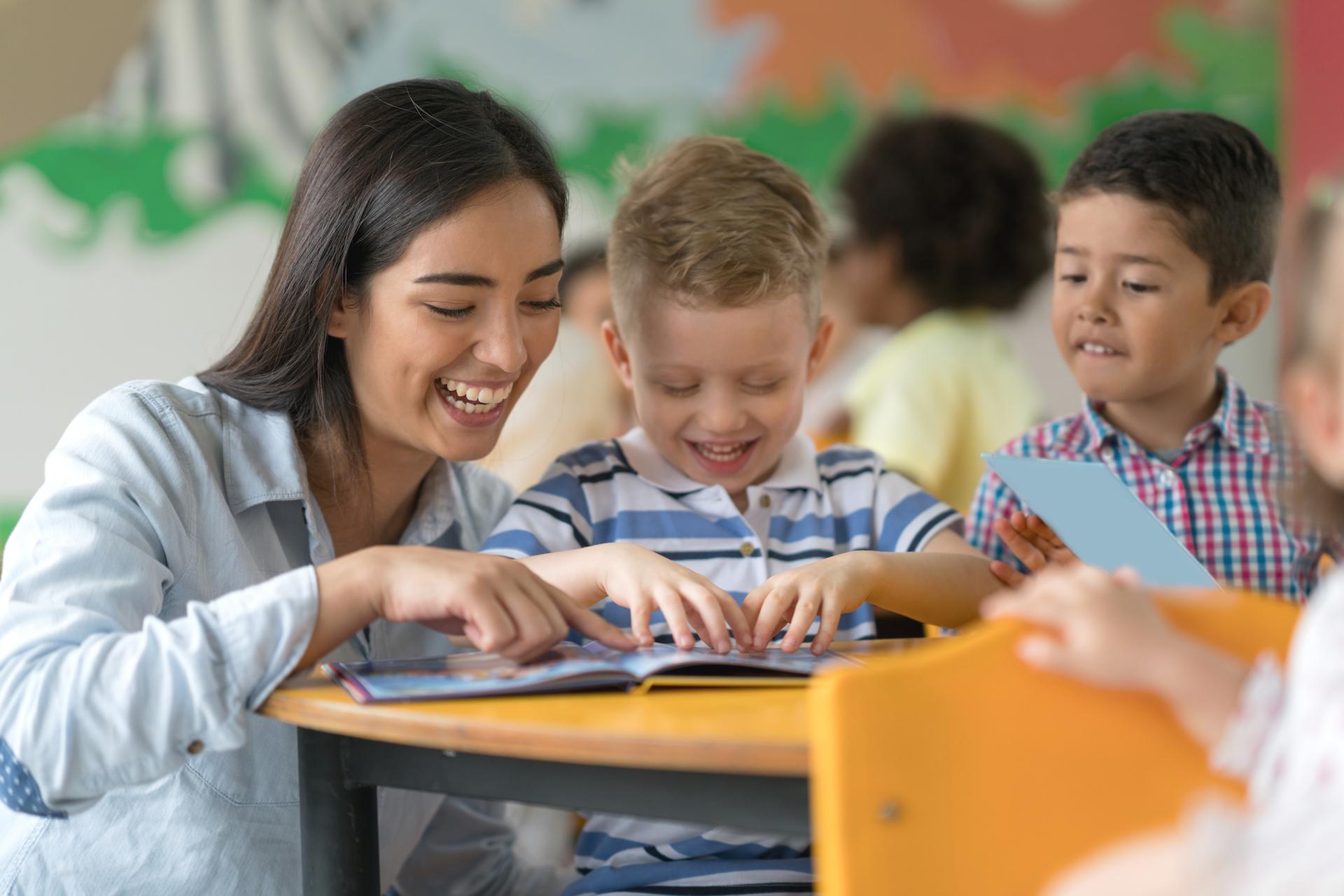 students reading with teacher